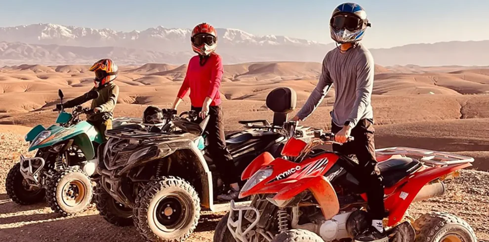 Three people riding buggies in the Agafay Desert